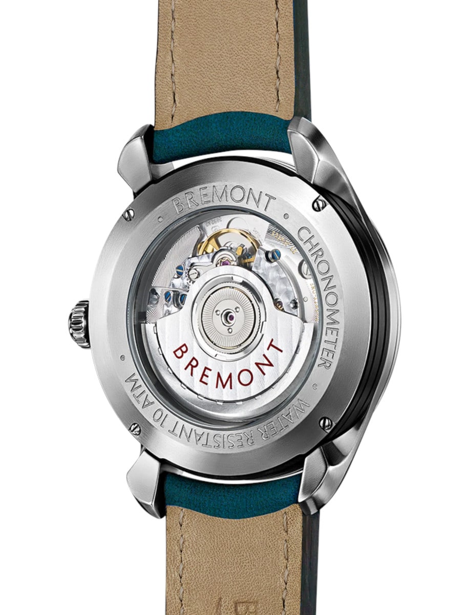 Bremont wristwatch with stainless steel case, open case back, and blue nubuck strap.