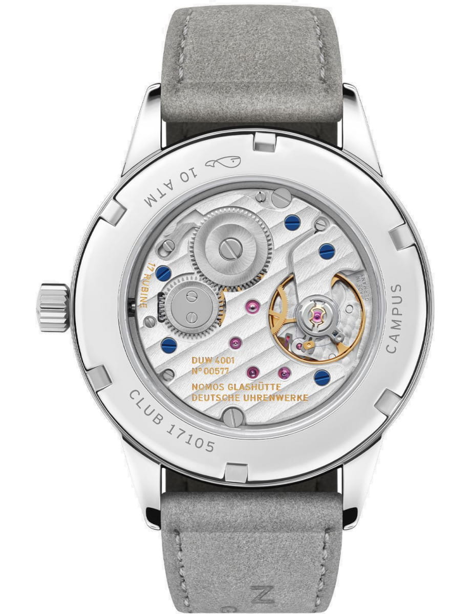Nomos wristwatch with stainless steel case, vegan velour strap, and sapphire crystal case back.