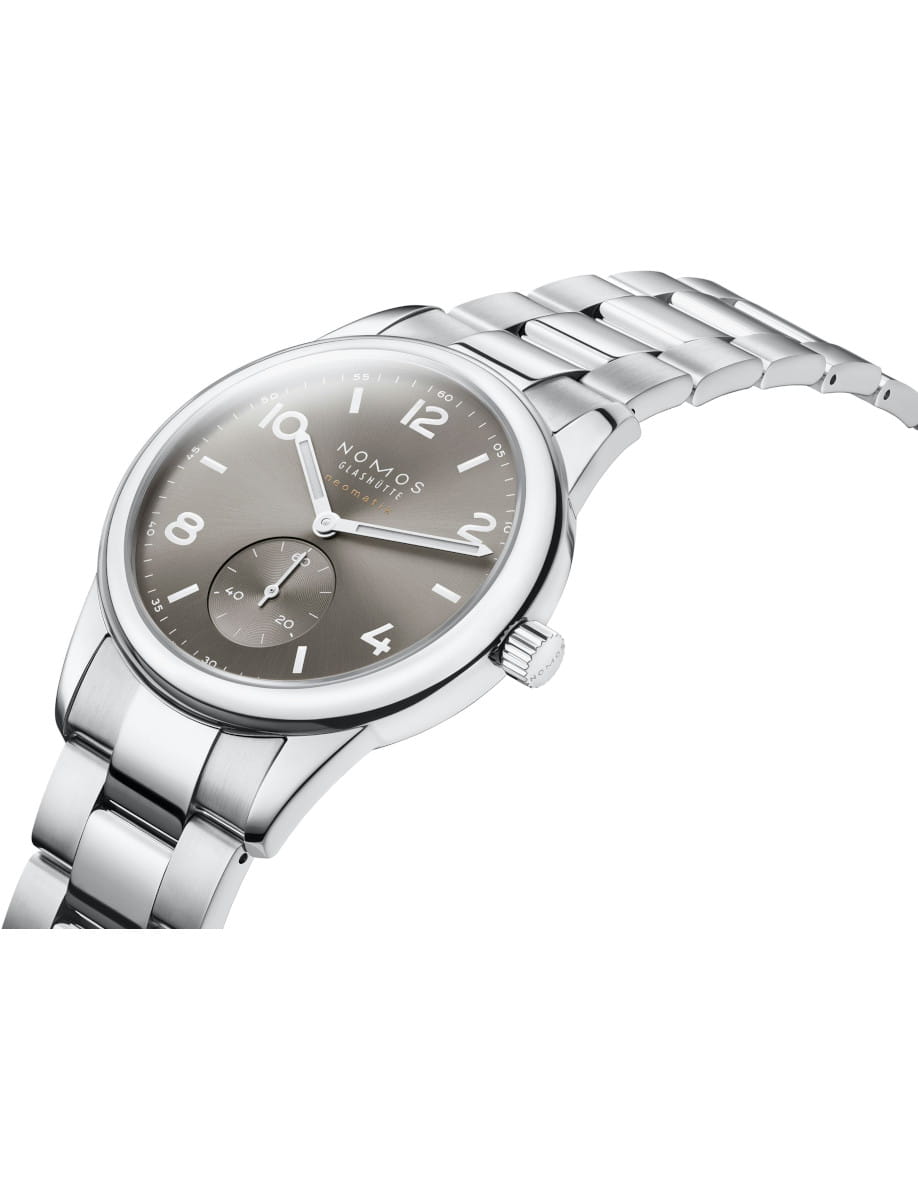 Close-up of a Nomos Glashutte wristwatch with stainless steel case and bracelet, and light grey dial.