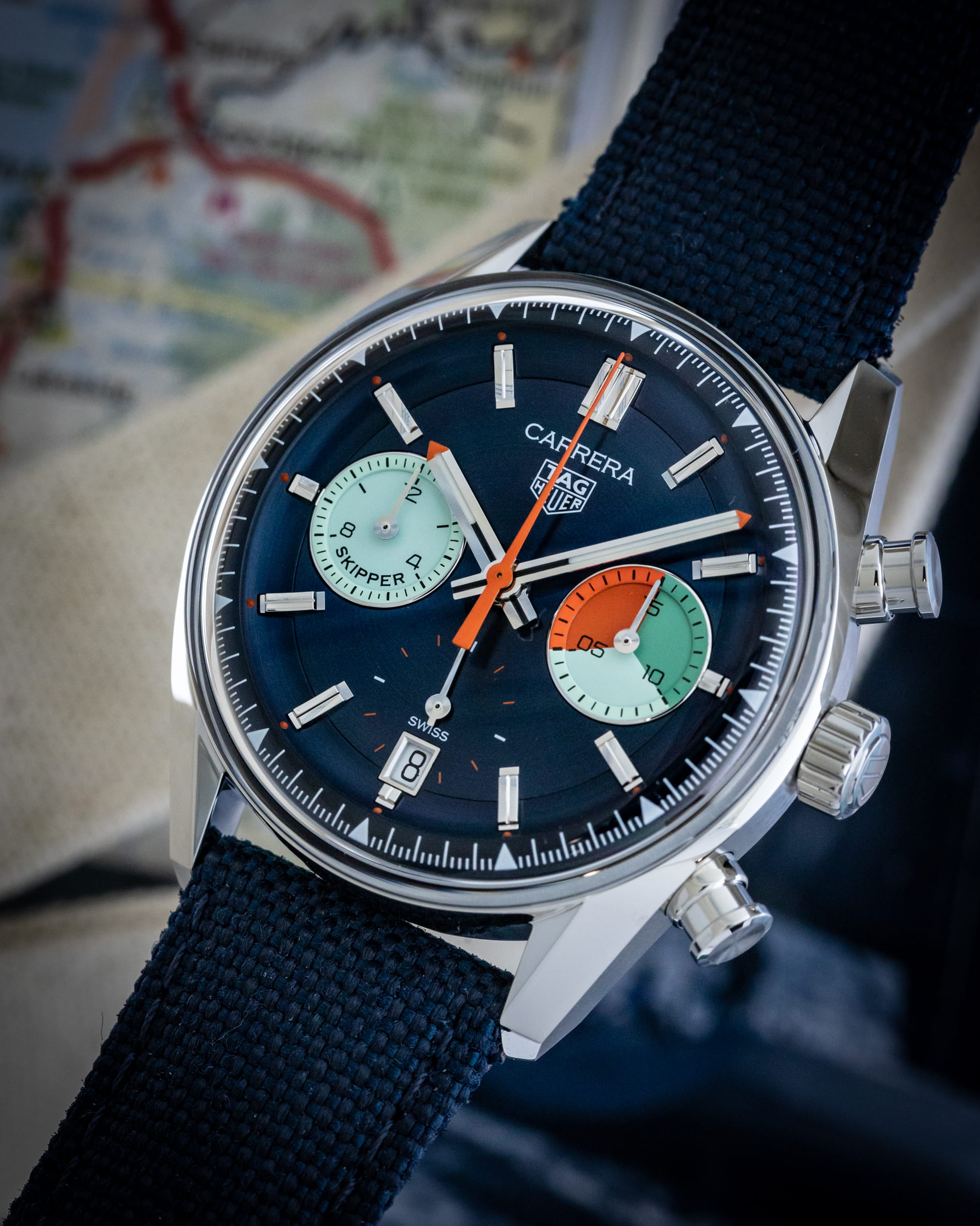 Hotlist image for Tag Heuer wristwatch with stainless steel case, multi-color dial, and blue textile strap.