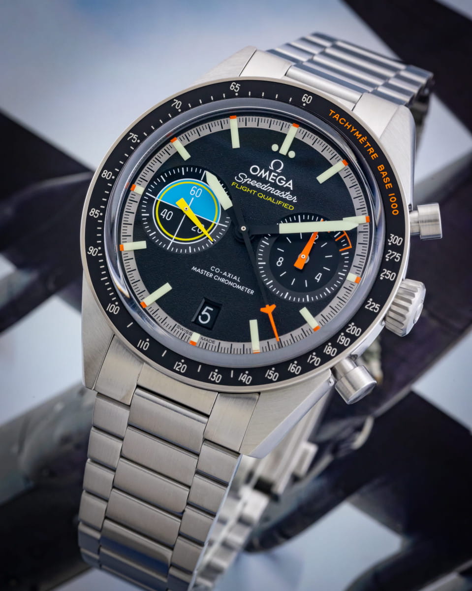 Omega wristwatch with stainless steel case and bracelet, and black dial.