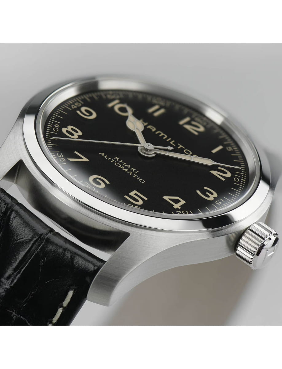 Side view of Hamilton wristwatch with stainless steel case, black dial, and black leather strap.