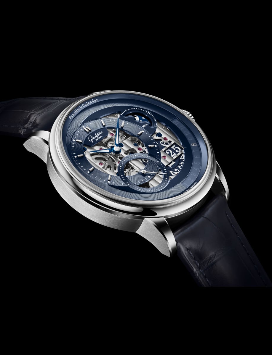 Side view of Glashütte Original wristwatch with platinum case, blue dial, and blue Louisiana Alligator leather strap.