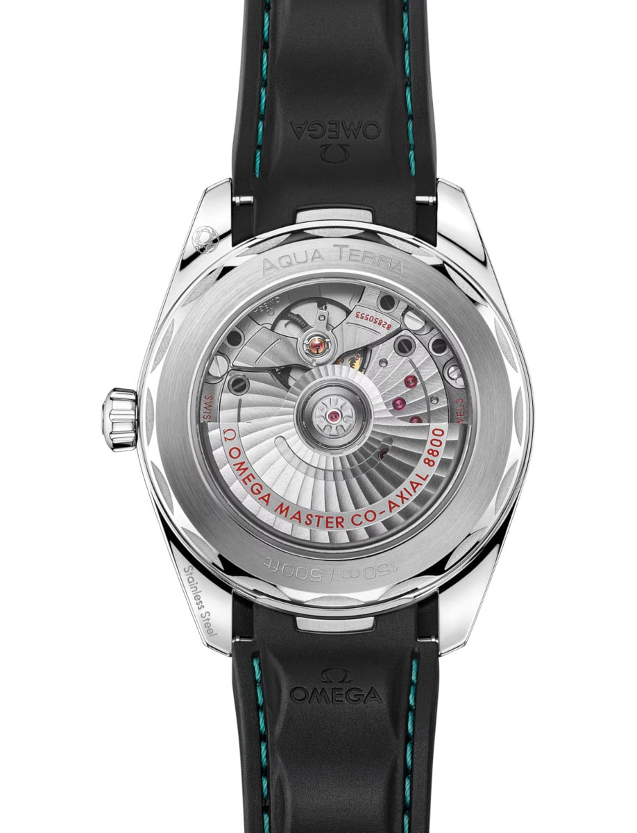 Back view of Omega wristwatch with exhibition case back, stainless steel case and black rubber strap.