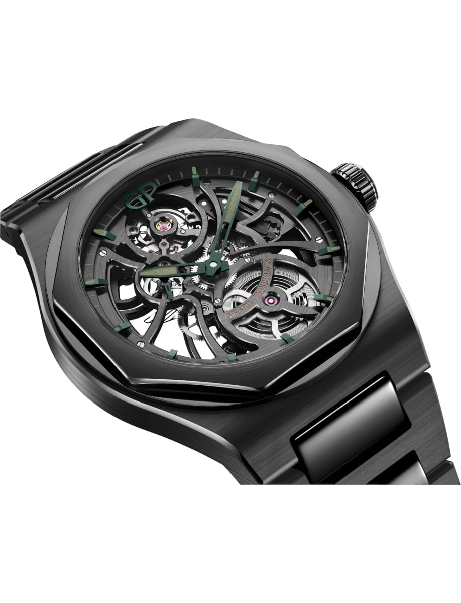 Side view of a black ceramic wristwatch showing the green-accented skeleton dial and integrated bracelet