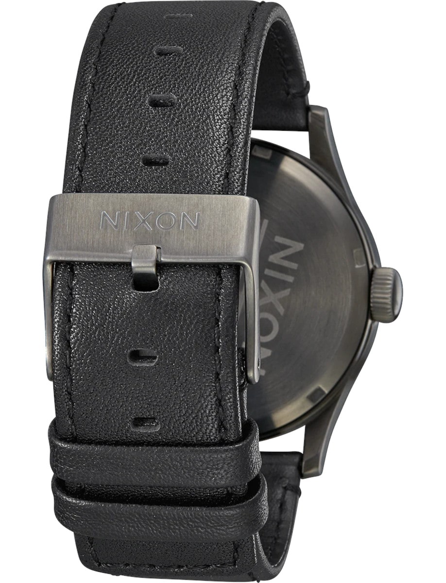 Back view of Nixon wristwatch with stainless steel case, and a black leather strap.