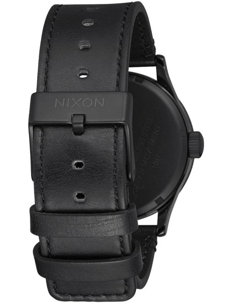 Back view of Nixon wristwatch with black stainless steel case, and a black leather strap.