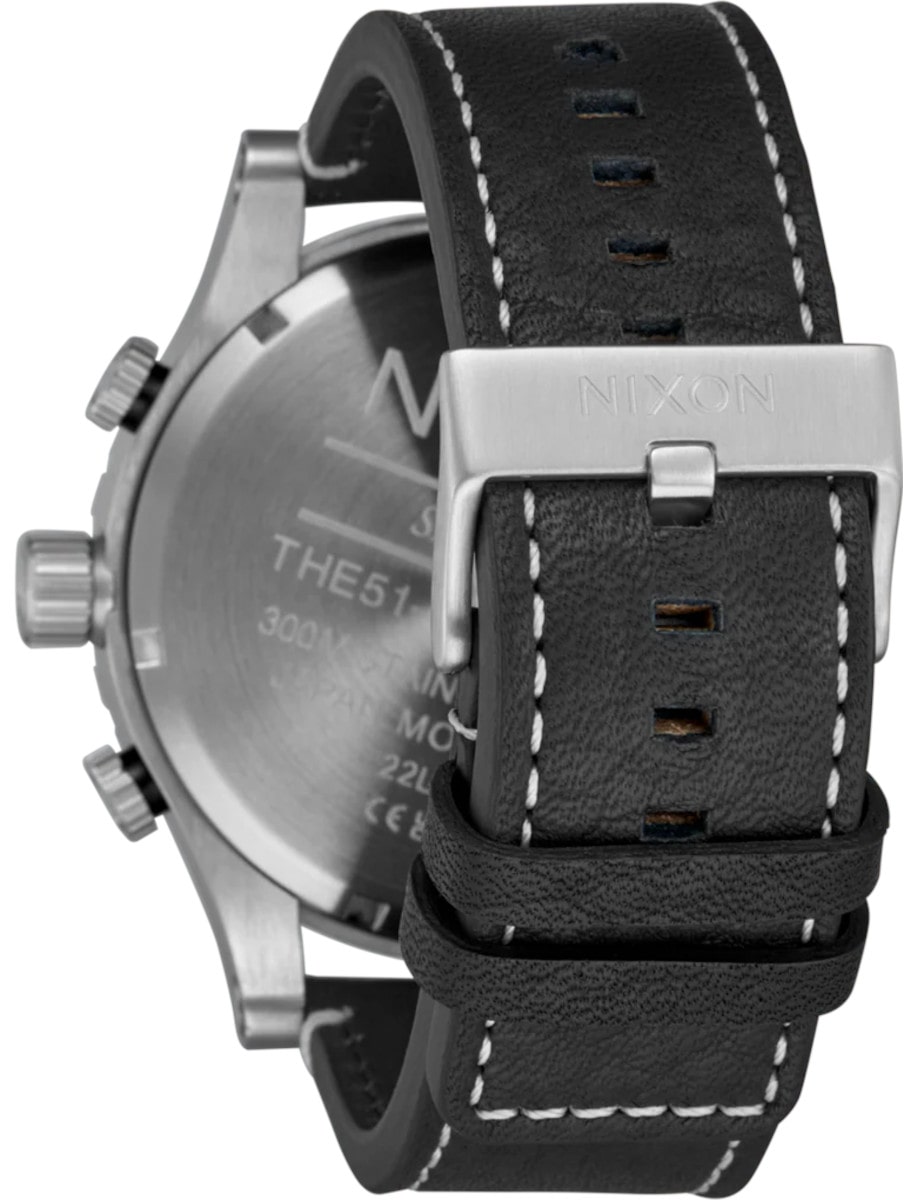 Back view of Nixon wristwatch with stainless steel case, and a black leather strap.