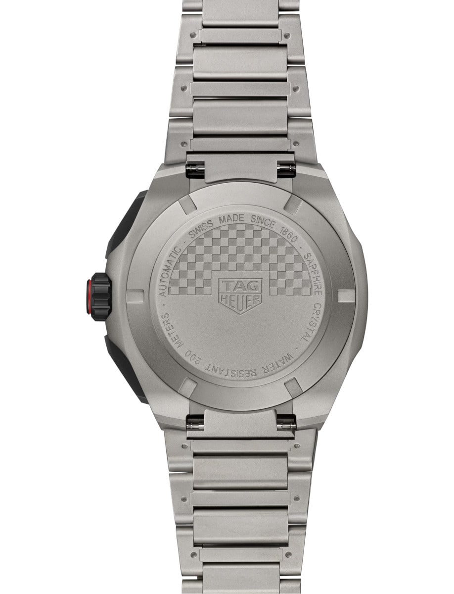 Back view of Tag Heuer wristwatch with titanium case and bracelet, and a black and red dial.