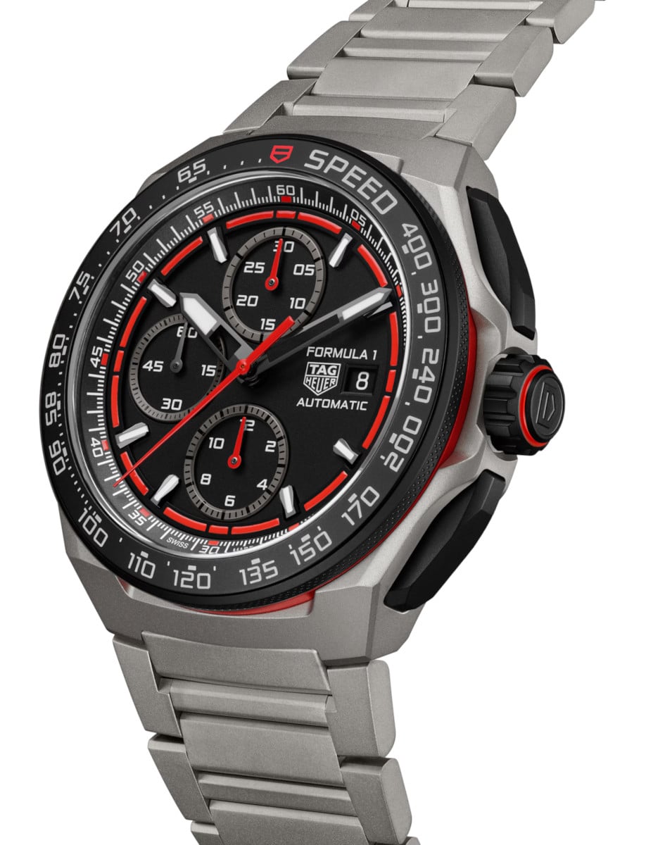 Side view of Tag Heuer wristwatch with titanium case and bracelet, and a black and red dial.