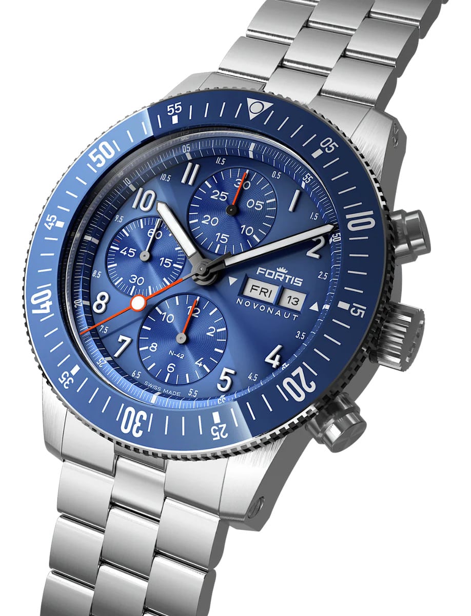 Side view of a wristwatch with a recycled stainless steel case and bracelet, and a blue dial.