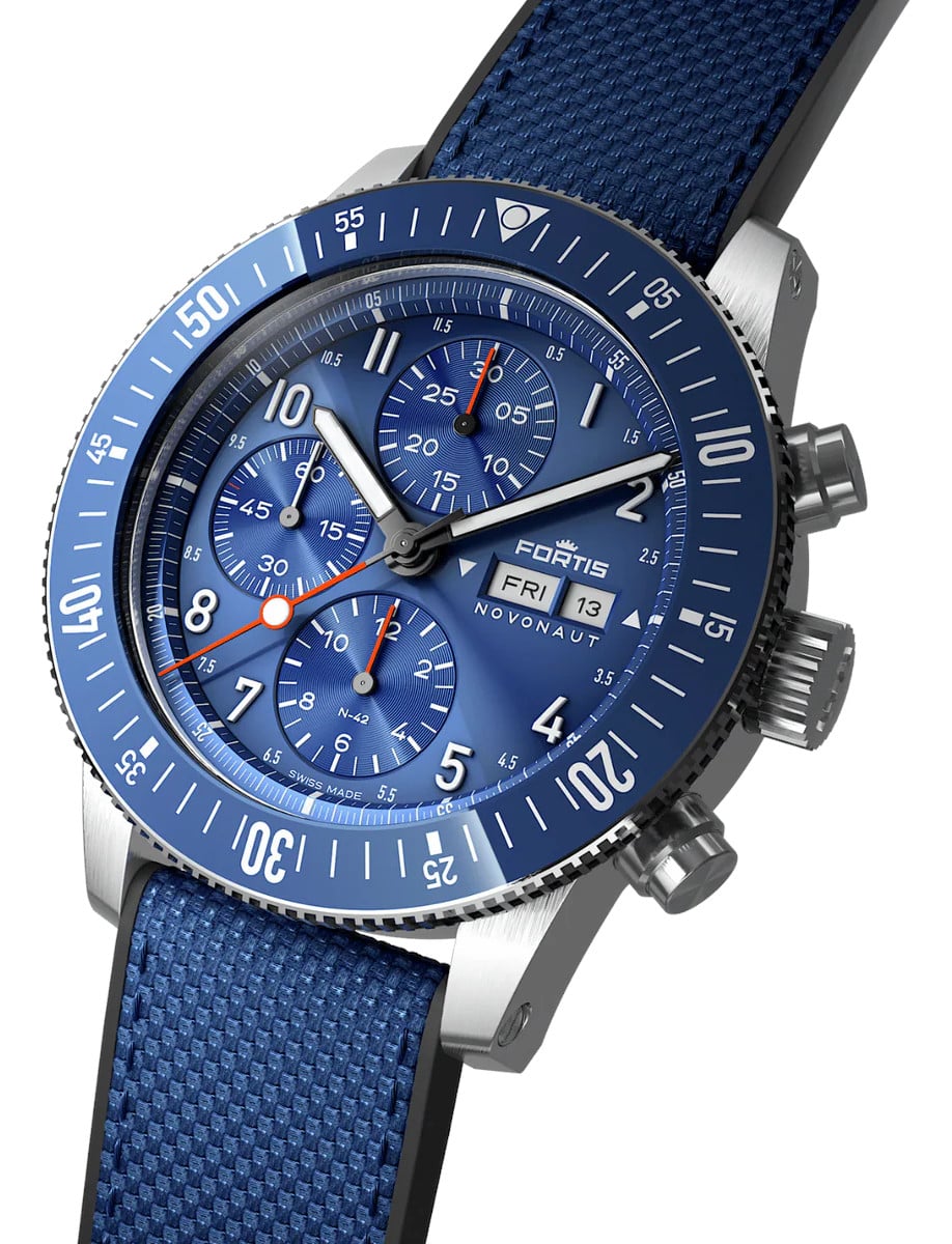 Side view of a wristwatch with a recycled stainless steel case, a blue dial, and a hybrid textile strap.