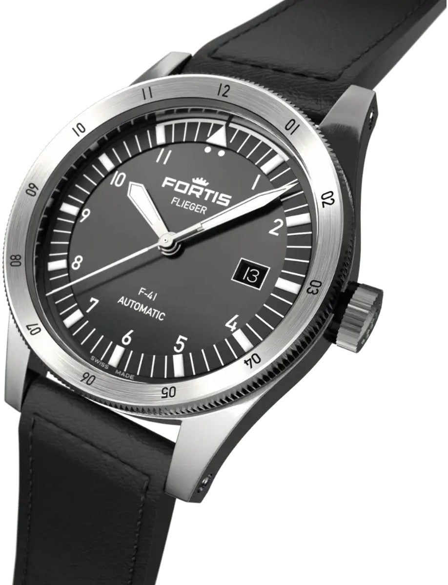 Side front view of a wristwatch with a recycled stainless steel case, a vertically brushed black dial, and a cowhide leather strap.