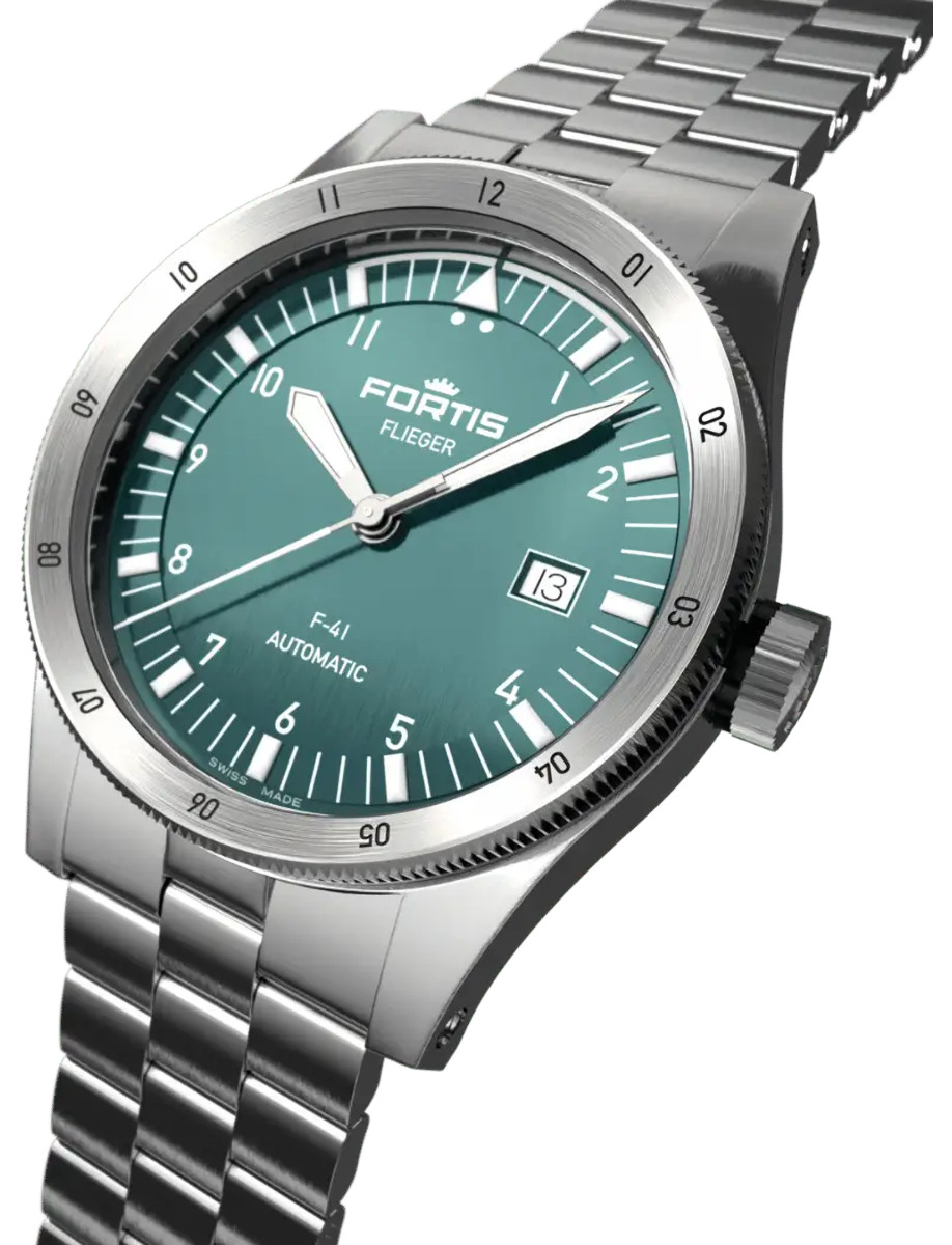 Side front view of a wristwatch with a recycled stainless steel case, vertically brushed petrol dial, and recycled stainless steel bracelet.