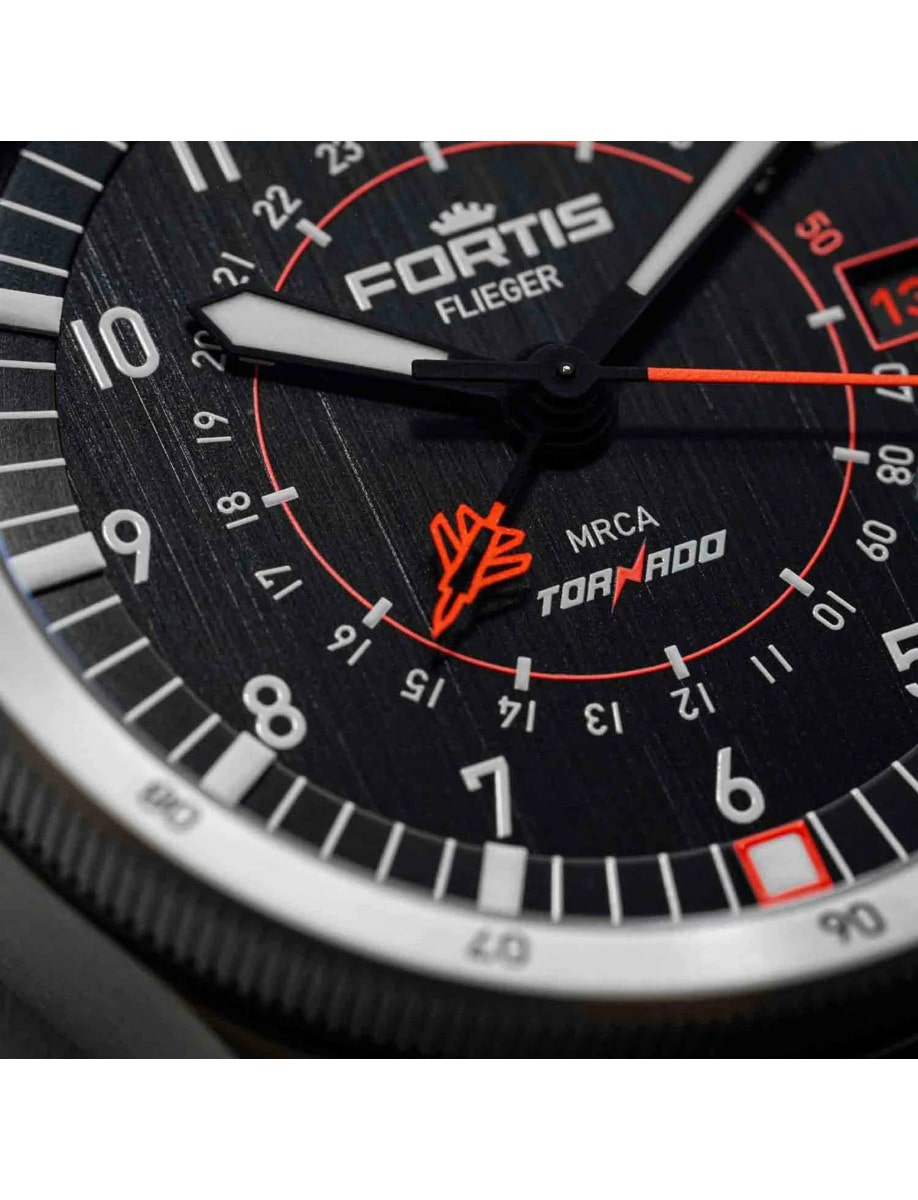 A wristwatch with a vertically brushed black dial featuring Roman numerals and luminescent markers.