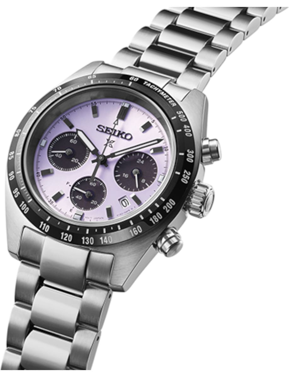 Side view of Seiko wristwatch with stainless steel case and bracelet, and purple dial.