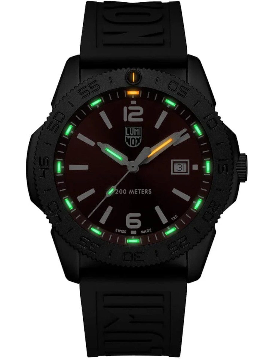 A wristwatch with an IP black stainless steel case, shown in the dark with glowing indexes and hands.