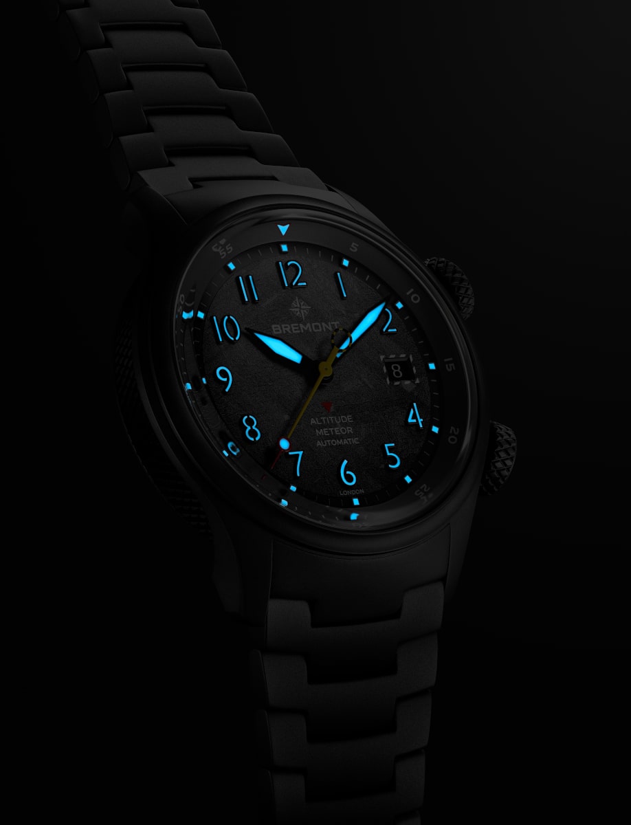 Night view of Bremont wristwatch with grade 2 titanium case and bracelet, and Super-LumiNova hands and numerals.
