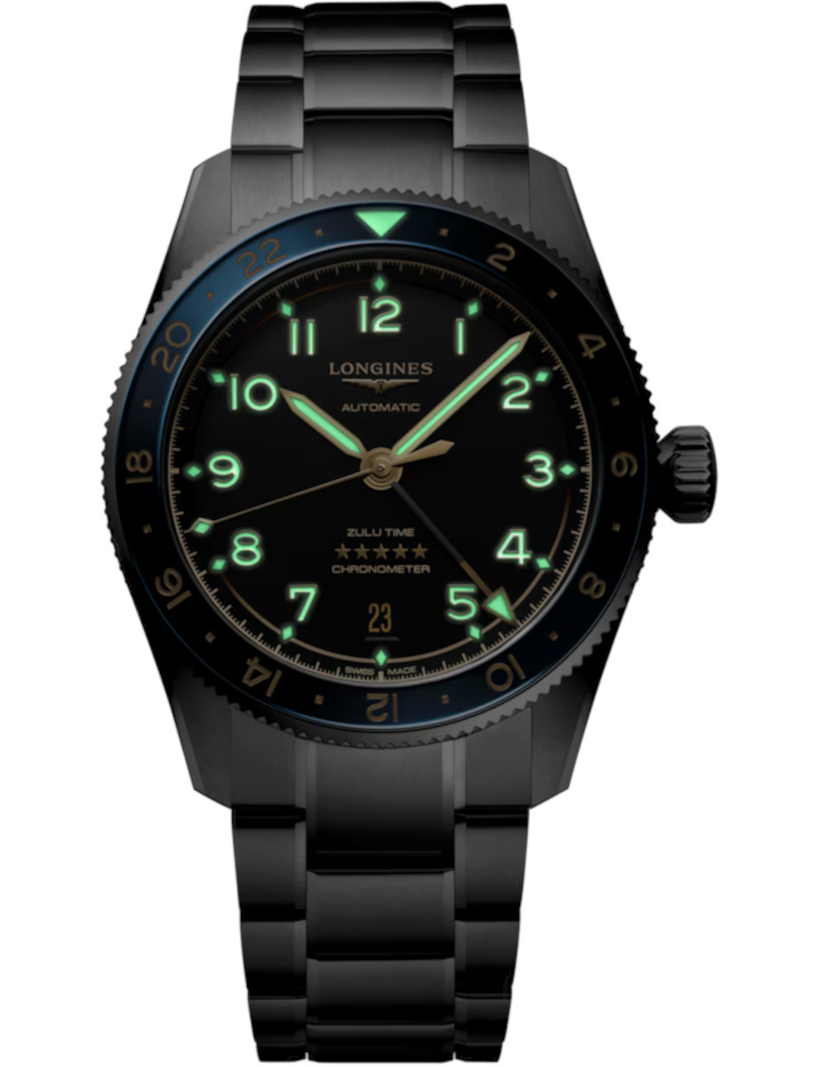 Night view of Longines wristwatch with stainless steel case and bracelet, glowing hands and numerals, and black dial.