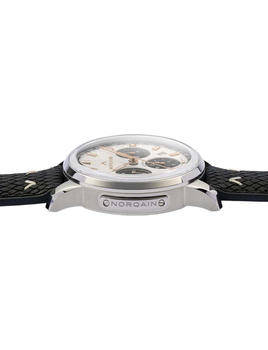 Side view of Norqain wristwatch with stainless steel case. off white dial, and black perlon rubber strap.