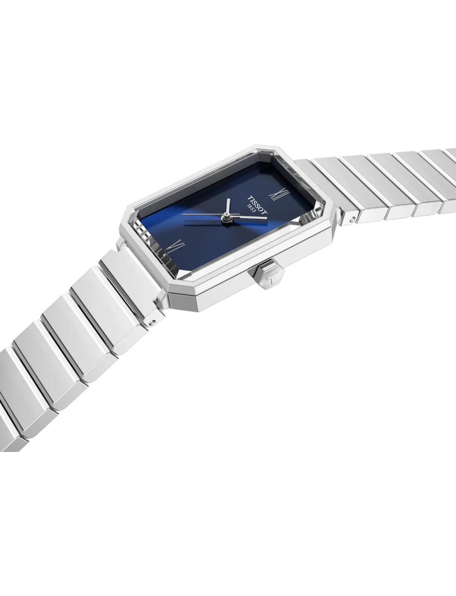 Side view of Tissot wristwatch with stainless steel case and bracelet, and blue dial.