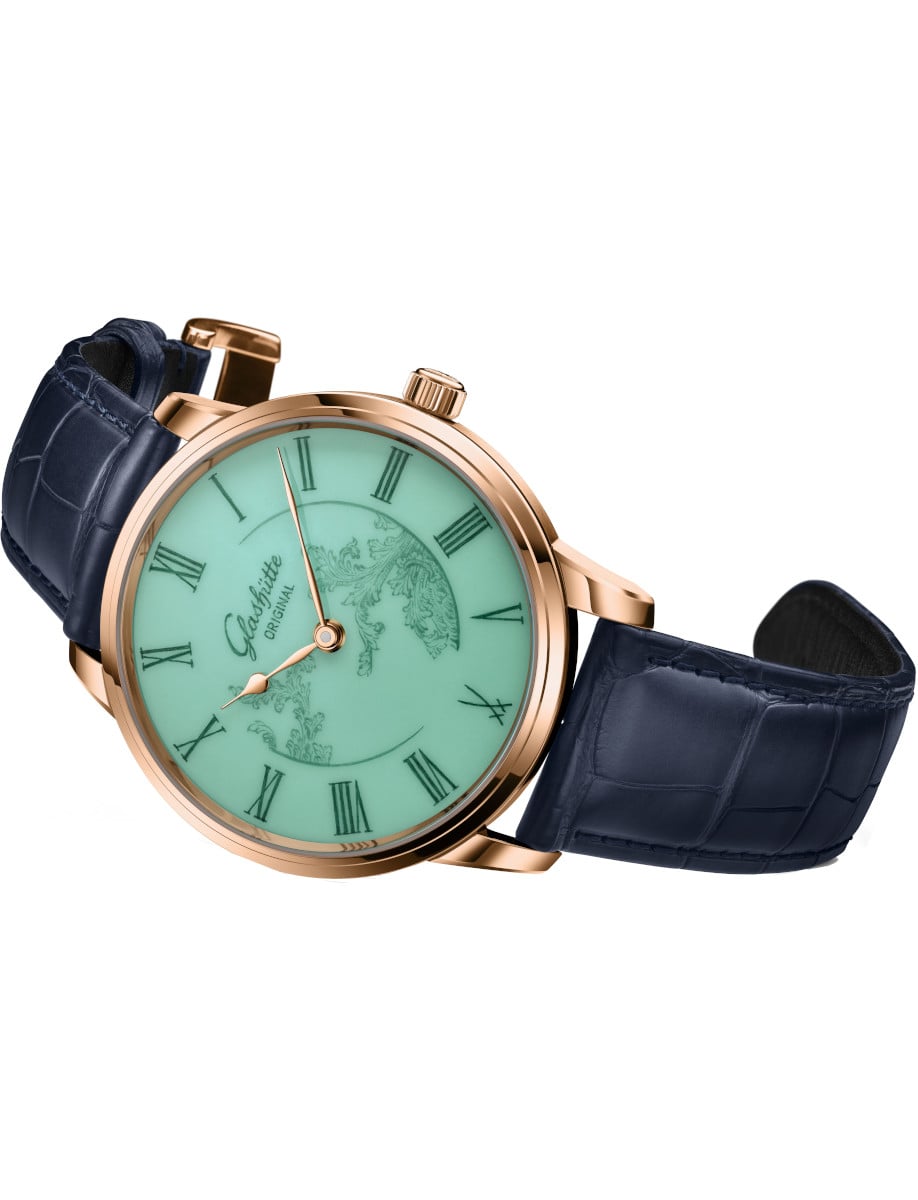 Side view of Glashutte Original wristwatch with red gold case, celadon green MEISSEN porcelain dial, and blue Louisiana Alligator leather strap