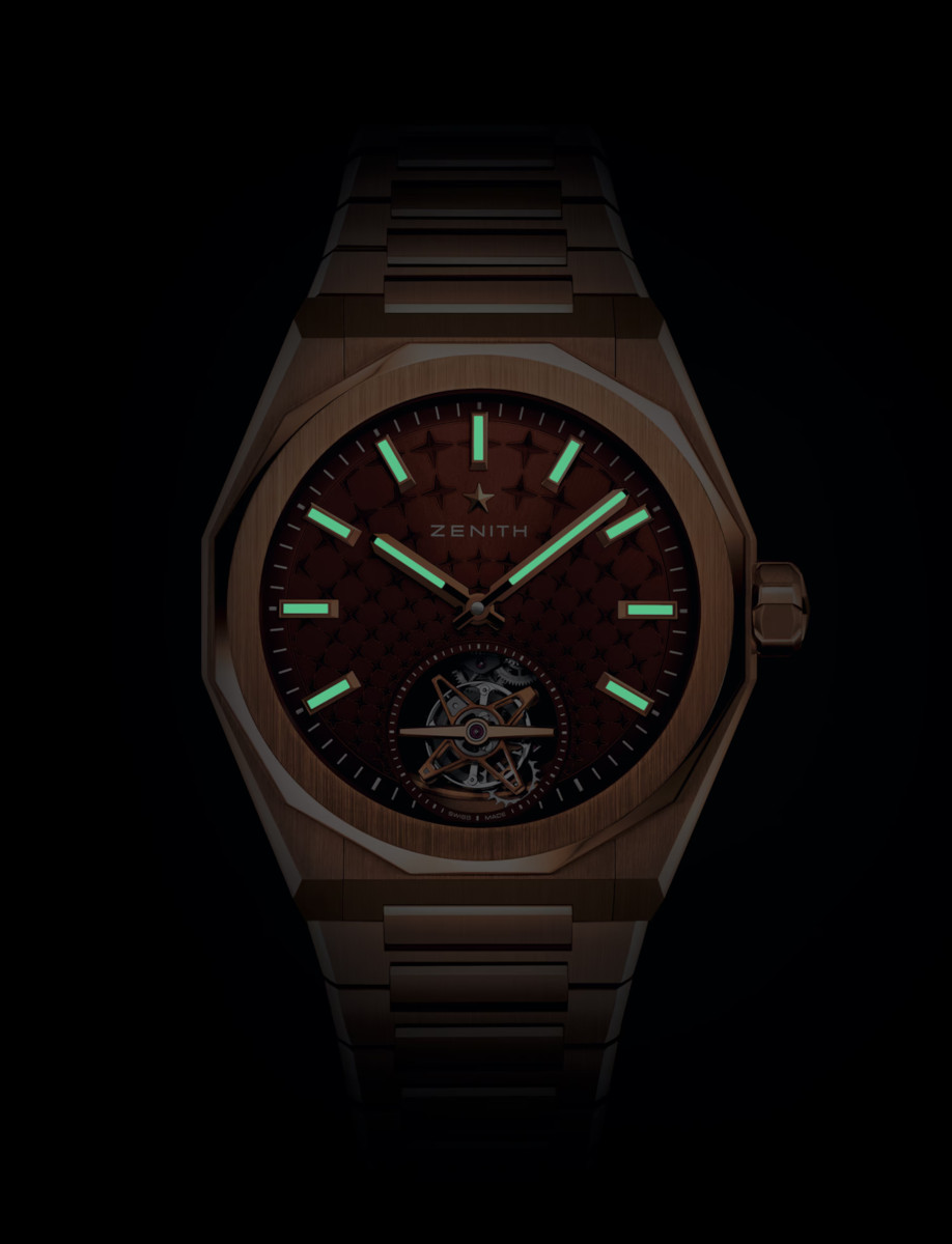 Zenith wristwatch with rose gold case and bracelet, and brick red sunray starry sky patterned dial with luminous hands and markers.