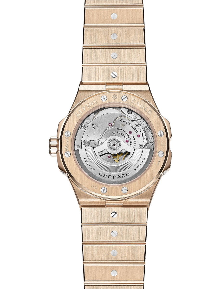 Back view of Chopard wristwatch with rose gold case and bracelet, and transparent case back.