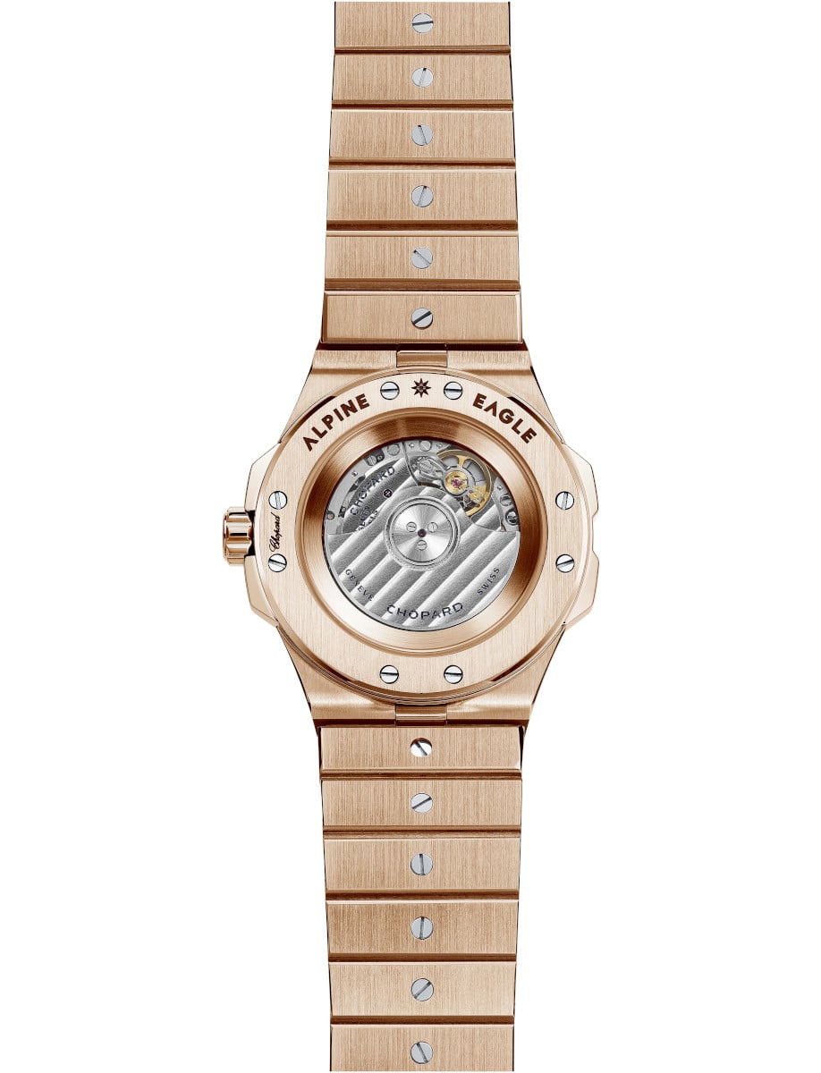 Back view of Chopard wristwatch with 18K rose gold case and bracelet with diamonds, and transparent case back.