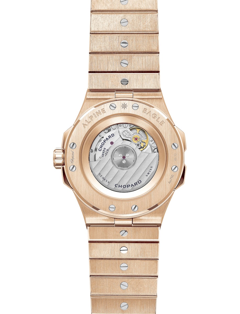 Back view of Chopard wristwatch with rose gold case and bracelet, and transparent case back.