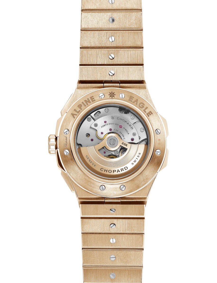 Back view of Chopard wristwatch with 18K rose gold case and bracelet, and transparent case back.