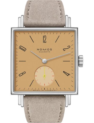 Nomos wristwatch with stainless steel case, ocher yellow dial, and vegan velour remborde beige strap.