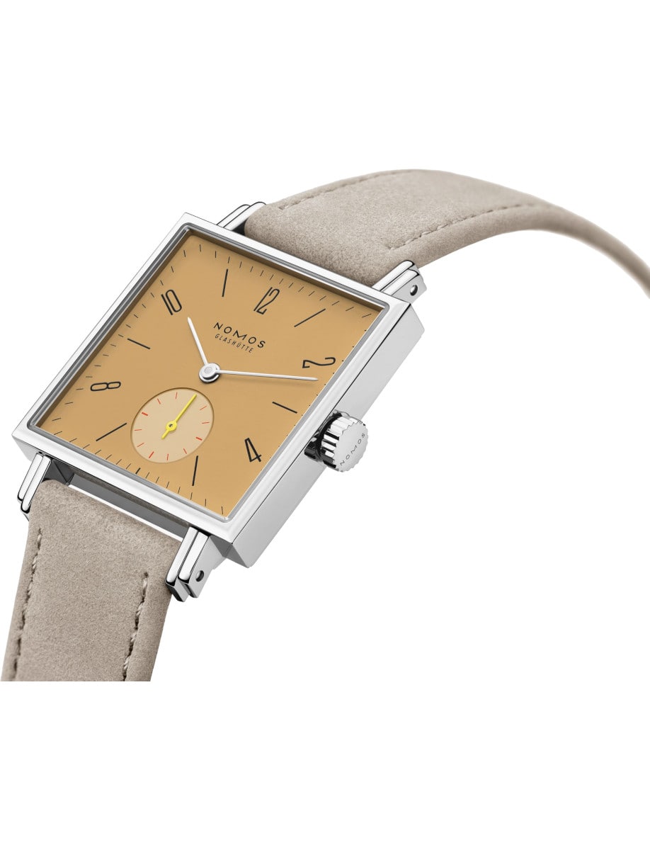 Side view of Nomos wristwatch with stainless steel case, ocher yellow dial, and vegan velour remborde beige strap.