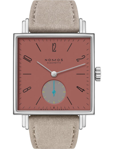 Nomos wristwatch with stainless steel case, terracotta red dial, and vegan velour remborde beige strap.