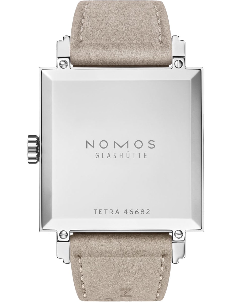 Side view of Nomos wristwatch with stainless steel case, and vegan velour remborde beige strap.