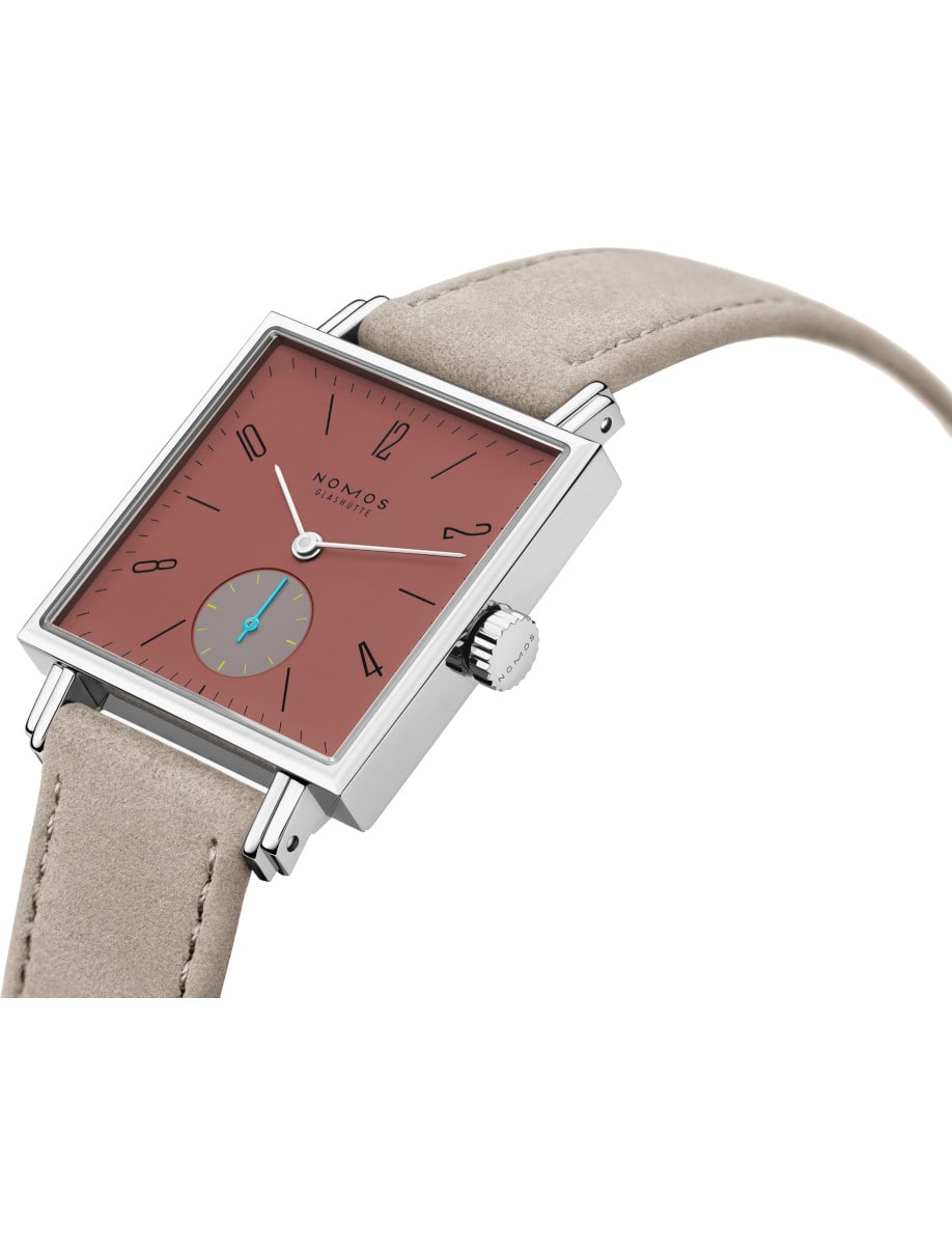 Side view of Nomos wristwatch with stainless steel case, terracotta red dial, and vegan velour remborde beige strap.