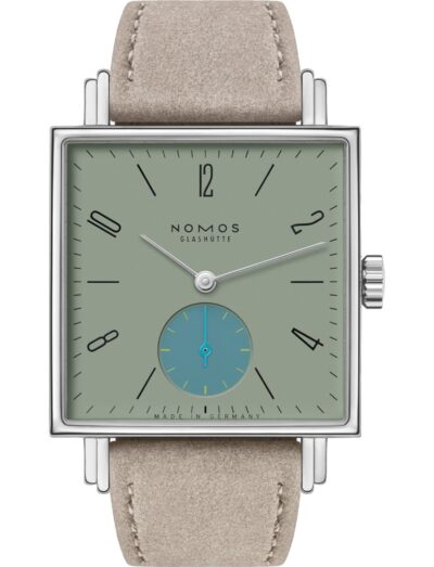 Nomos wristwatch with stainless steel case, sage green dial, and vegan velour remborde beige strap.