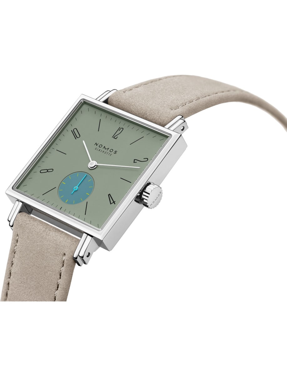 Side view of Nomos wristwatch with stainless steel case, sage green dial, and vegan velour remborde beige strap.