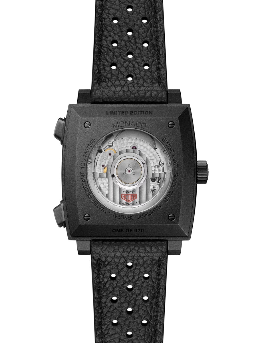 Back view of Tag Heuer wristwatch with titanium case with transparent case back, and black leather strap.