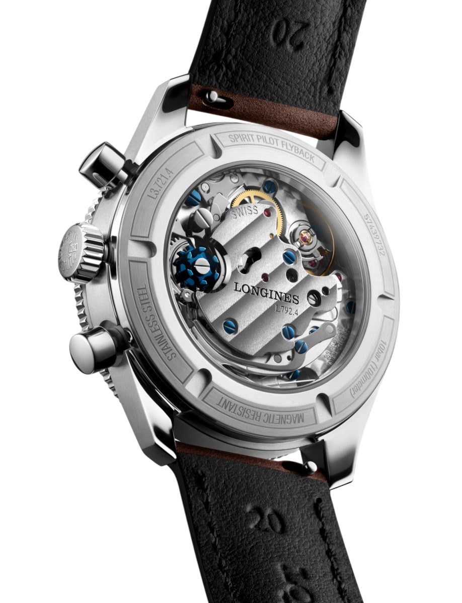 Back view of Longines wristwatch with stainless steel case, brown leather strap, and transparent case back.