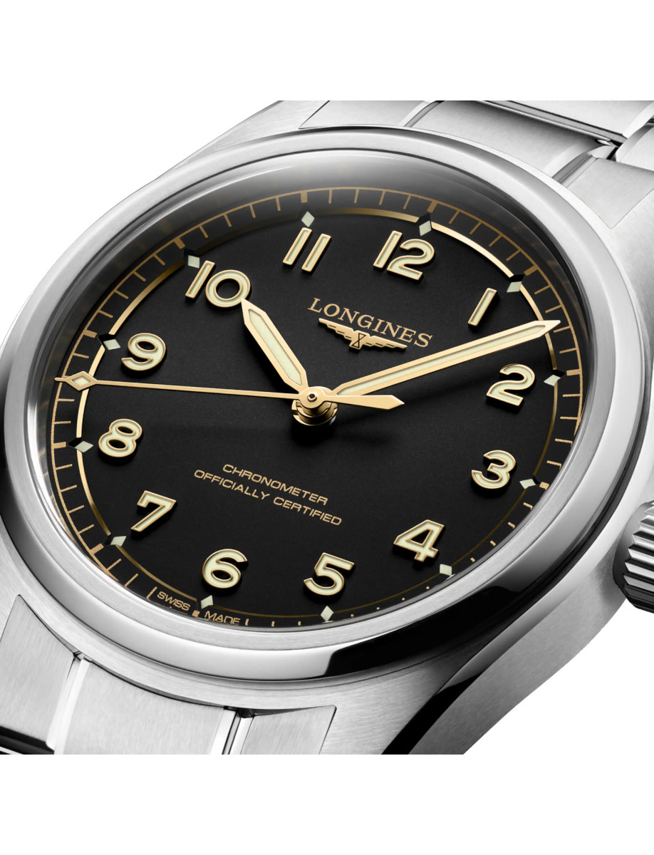 Close view of dial of Longines wristwatch with stainless steel case and bracelet, and black dial.