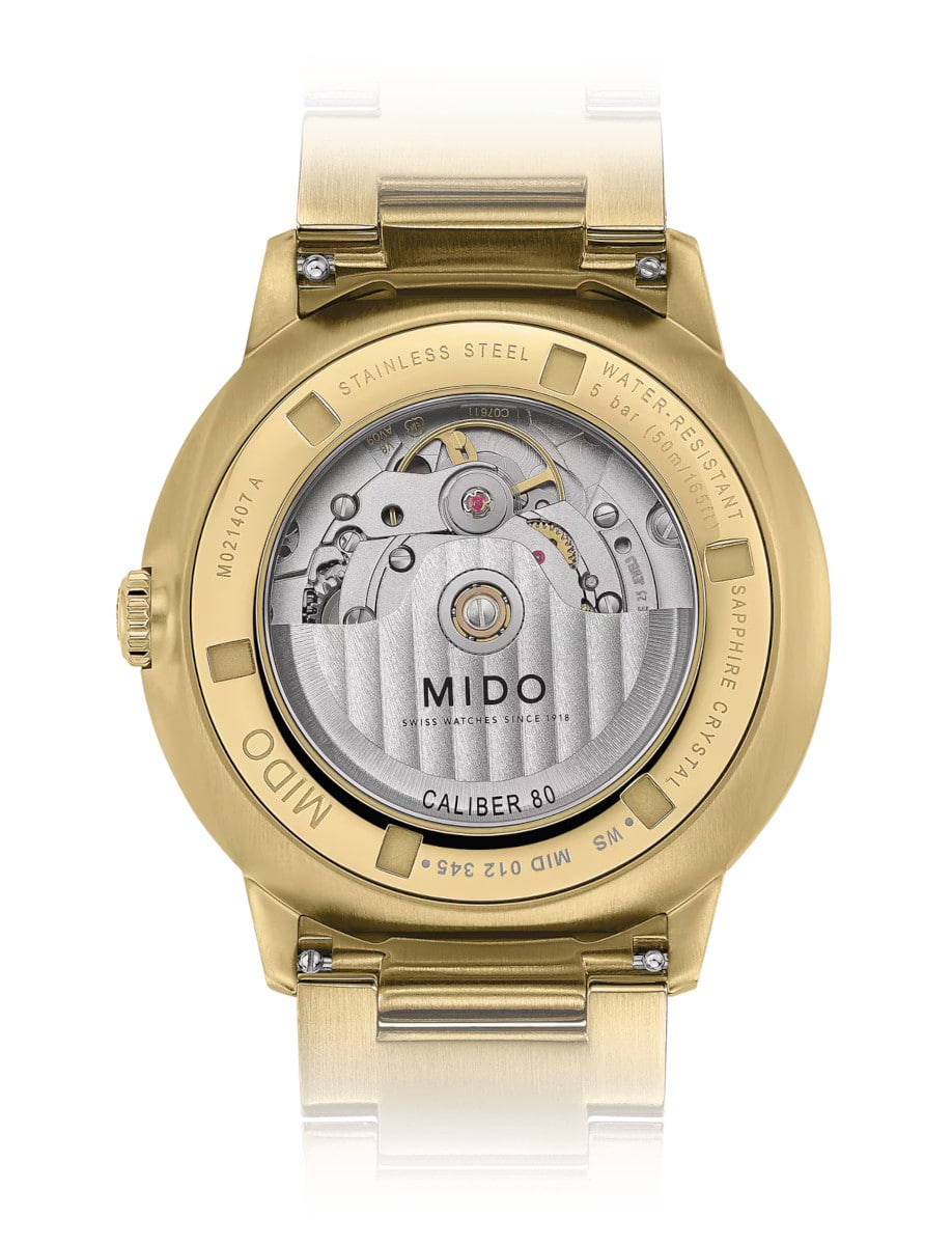 Mido wristwatch with stainless steel with yellow gold colour PVD coating case and bracelet, and transparent case back.