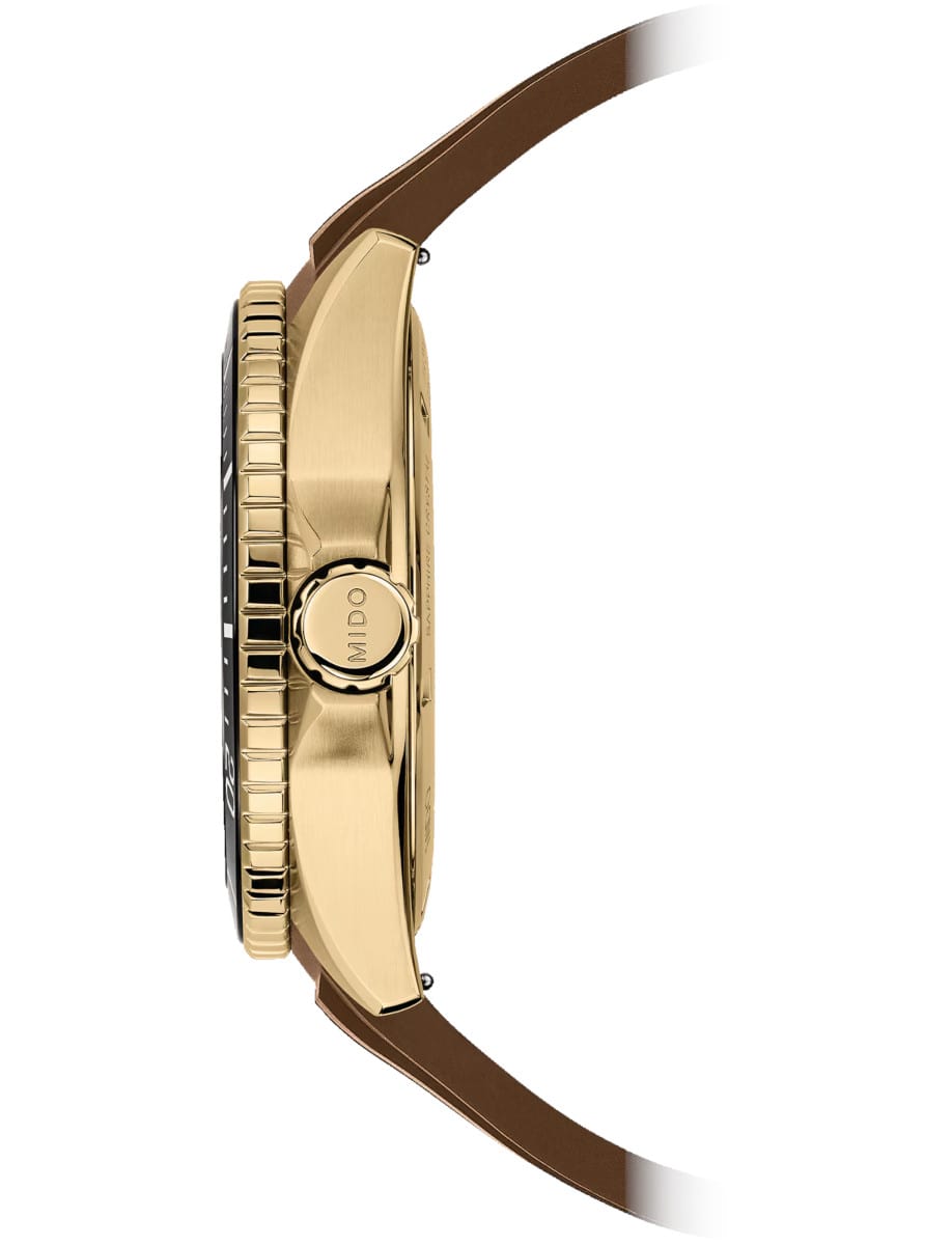 Side view of Mido wristwatch with stainless steel yellow pvd case and syntetic strap