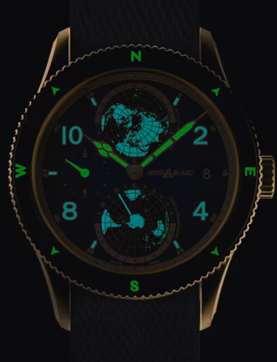 Montblanc wristwatch with bronze case, blue dial with beige luminescent Arabic numerals and indexes, and luxury blue textile strap.