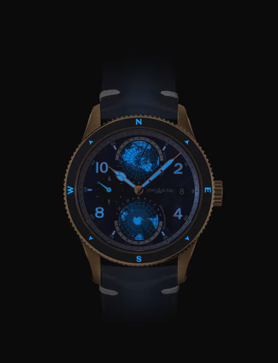 Night view of Montblanc wristwatch with bronze case, blue dial with luminous hands and indexes , and blue leather strap.