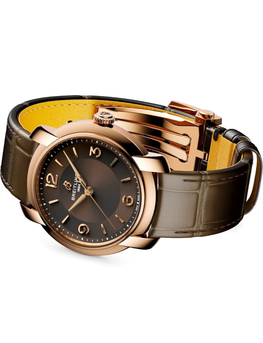 Side view of Breitling wristwatch with 18k red gold, brown dial, and brown alligator leather.