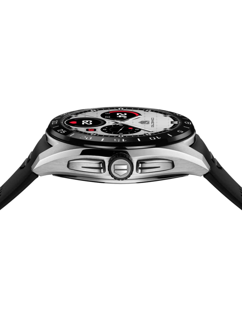 Side view of Tag Heuer wristwatch with stainless steel case, OLED display, and black rubber strap.