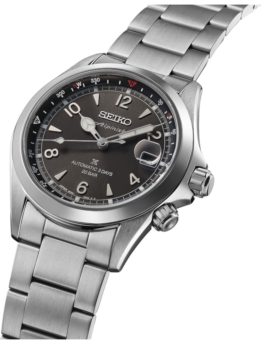 Side view of Seiko wristwatch with stainless steel case and bracelet, and black dial.