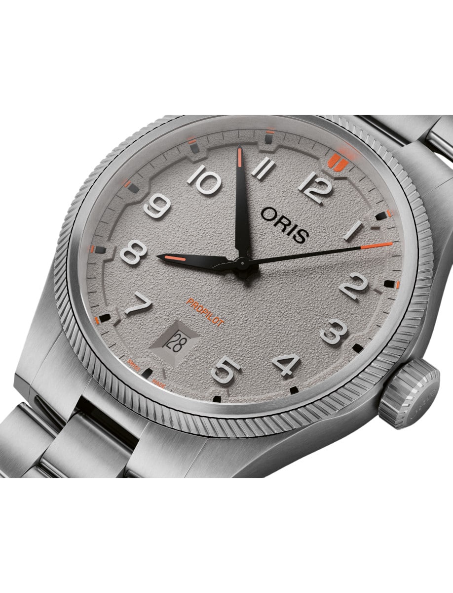 Side view of Oris wristwatch with stainless steel case and bracelet, and beige dial.