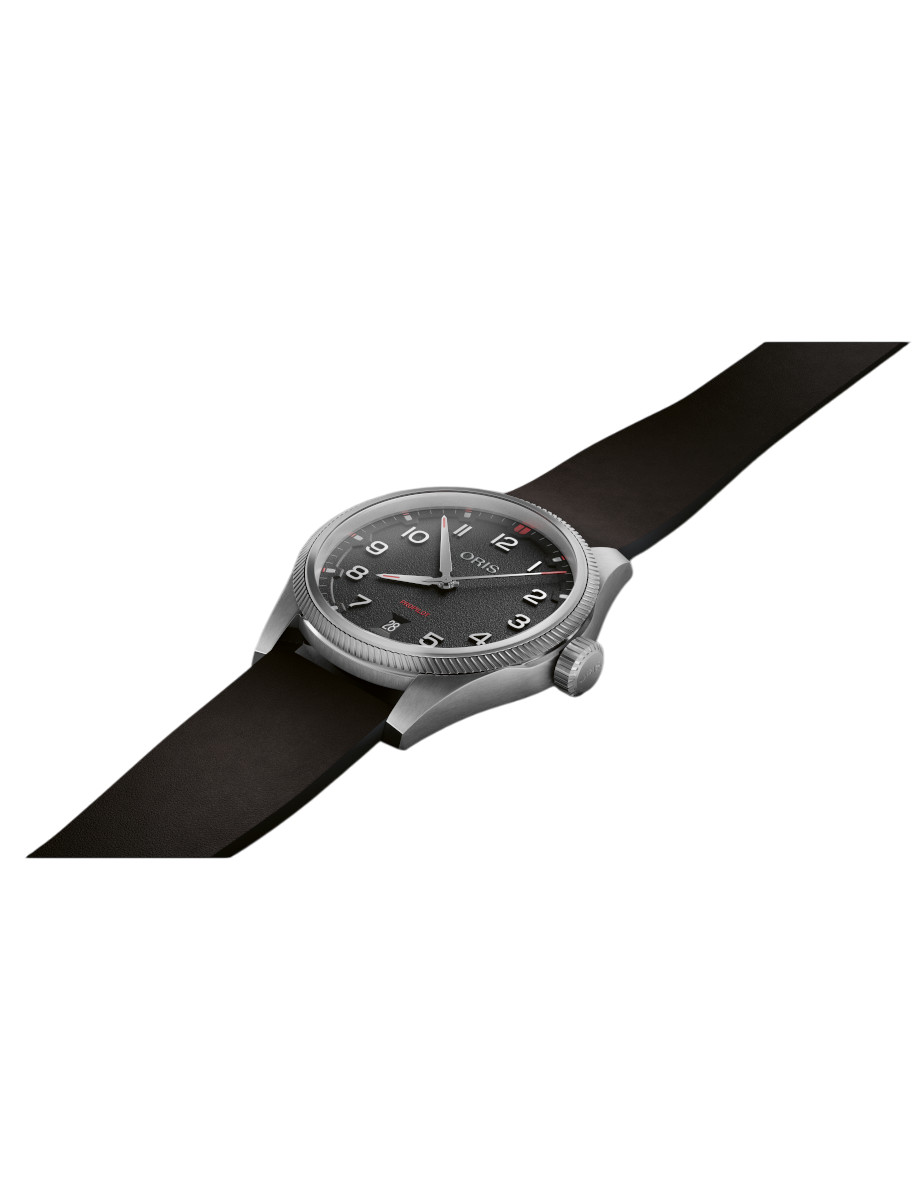 Side view of Oris wristwatch with stainless steel case, black dial, and black suede leather strap.